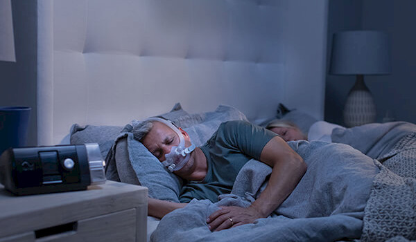 Patient getting a good night's sleep with CPAP machine.