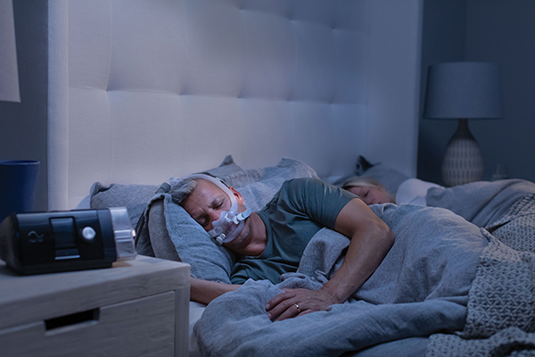 Patient getting a good night's sleep with CPAP machine.